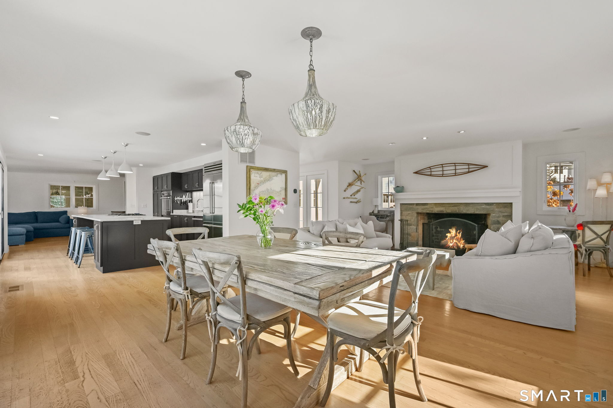 a view of a dining room with furniture wooden floor and a fireplace