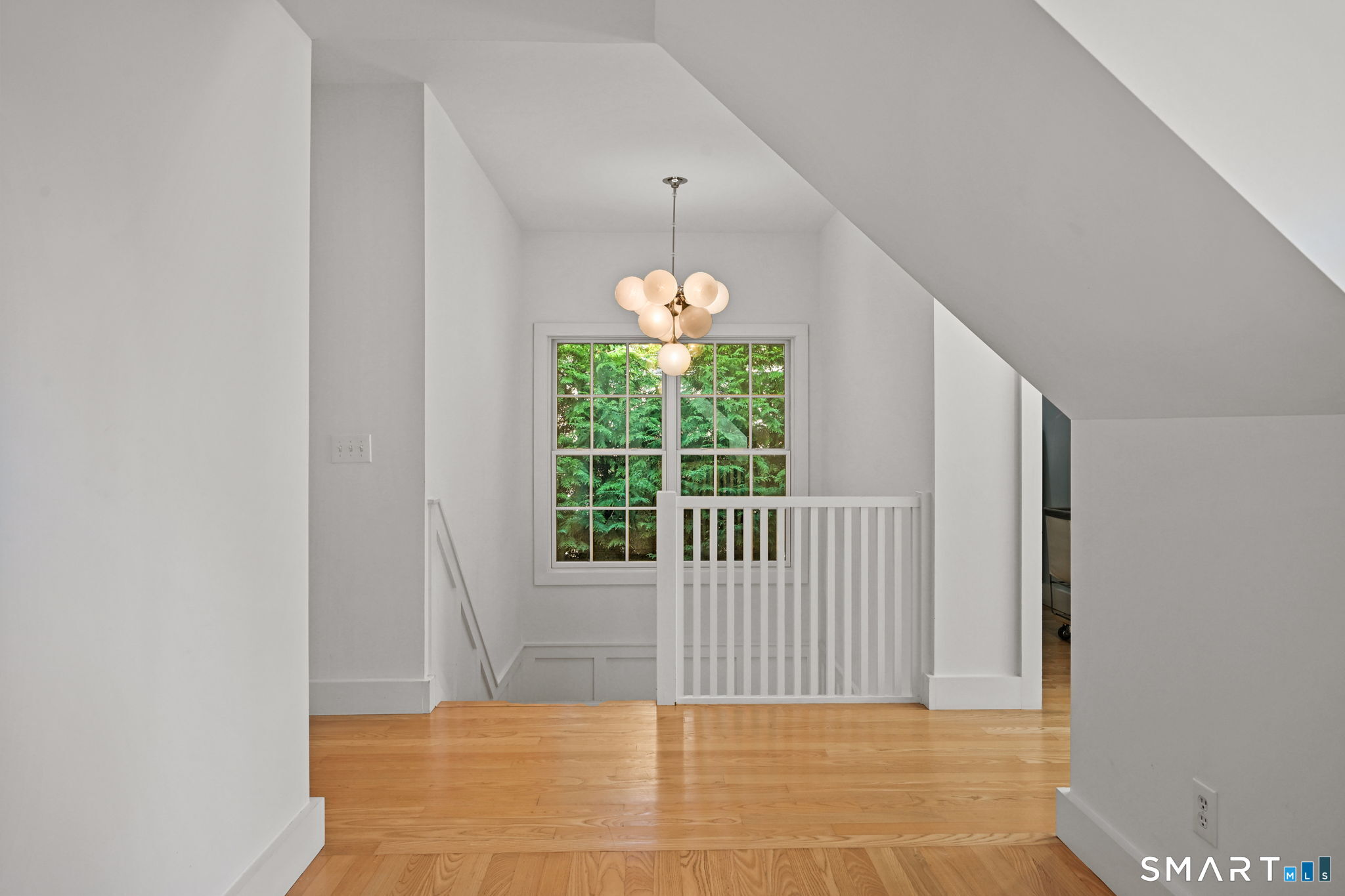 150 Hillspoint Road Westport, CT 06880 - Photo 11 of 40 a view of a hallway with windows and chandelier