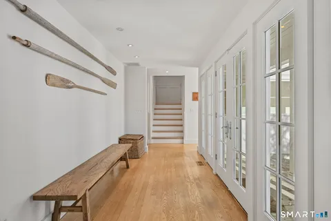a view of a hallway with wooden floor and staircase