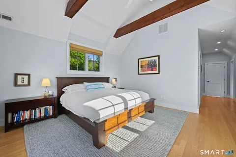 a bed sitting in a bedroom next to a lamp