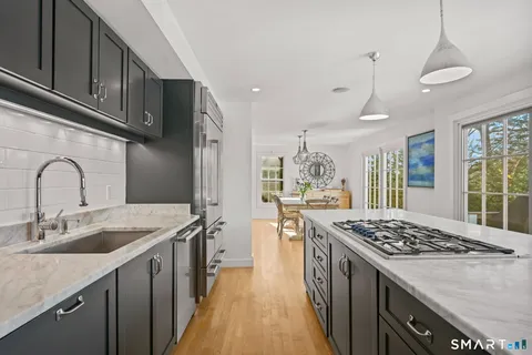 a kitchen with a sink stove and refrigerator