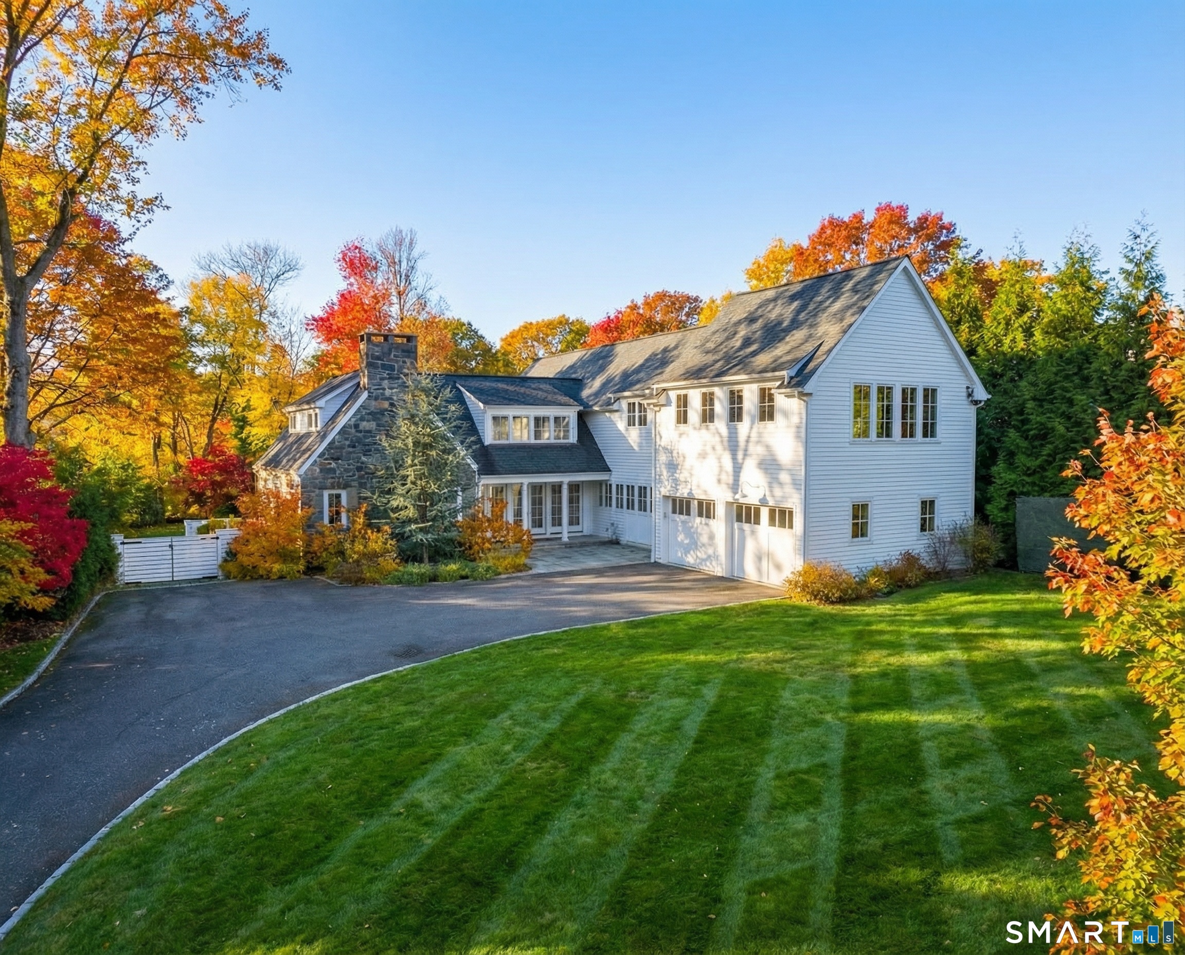 150 Hillspoint Road Westport, CT 06880 - Photo 40 of 40 a front view of a house with a yard and garage