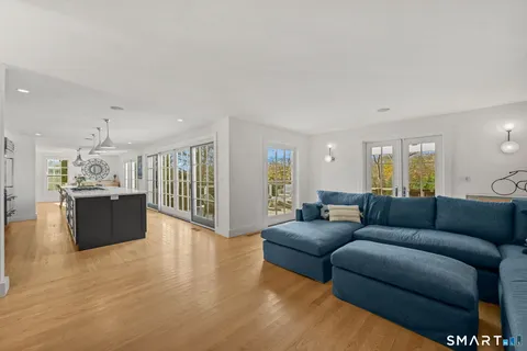 a living room with furniture and kitchen view