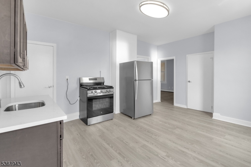 215 Delaware Street, Unit 6 Elizabeth Port, NJ 07206 - Photo 3 of 11 a kitchen with a refrigerator sink and cabinets
