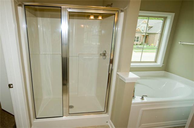 2007 Rudder Court Spring Hill, TN 37174 - Photo 8 of 18 Oversized shower with glass door and a deep soaking tub, included. Stock photo in a different color pallet.