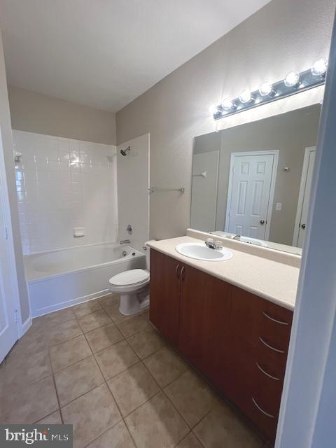 13501 Kildare Hills Terrace, Unit 402 Germantown, MD 20874 - Photo 12 of 14 a bathroom with a sink a toilet a mirror and a shower
