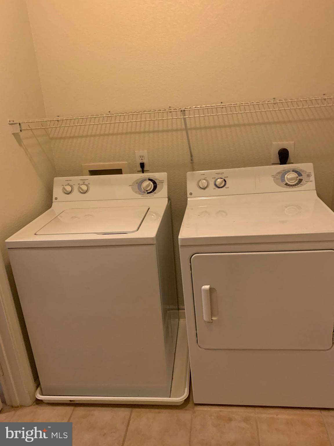 13501 Kildare Hills Terrace, Unit 402 Germantown, MD 20874 - Photo 13 of 14 a utility room with dryer and washer