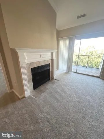 an empty room with furniture and a fireplace