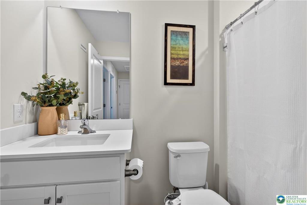 1274 Martin Road Breinigsville, PA 18031 - Photo 15 of 18 Clean lines and stone counters define this modern, neutral bathroom space.