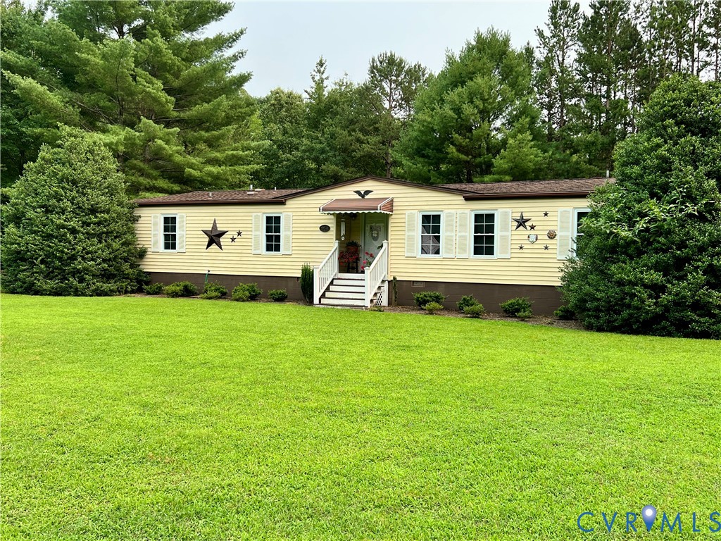 19541 Templeton Road Carson, VA 23830 - Photo 2 of 2 Yellow vinyl siding exterior with white window shu