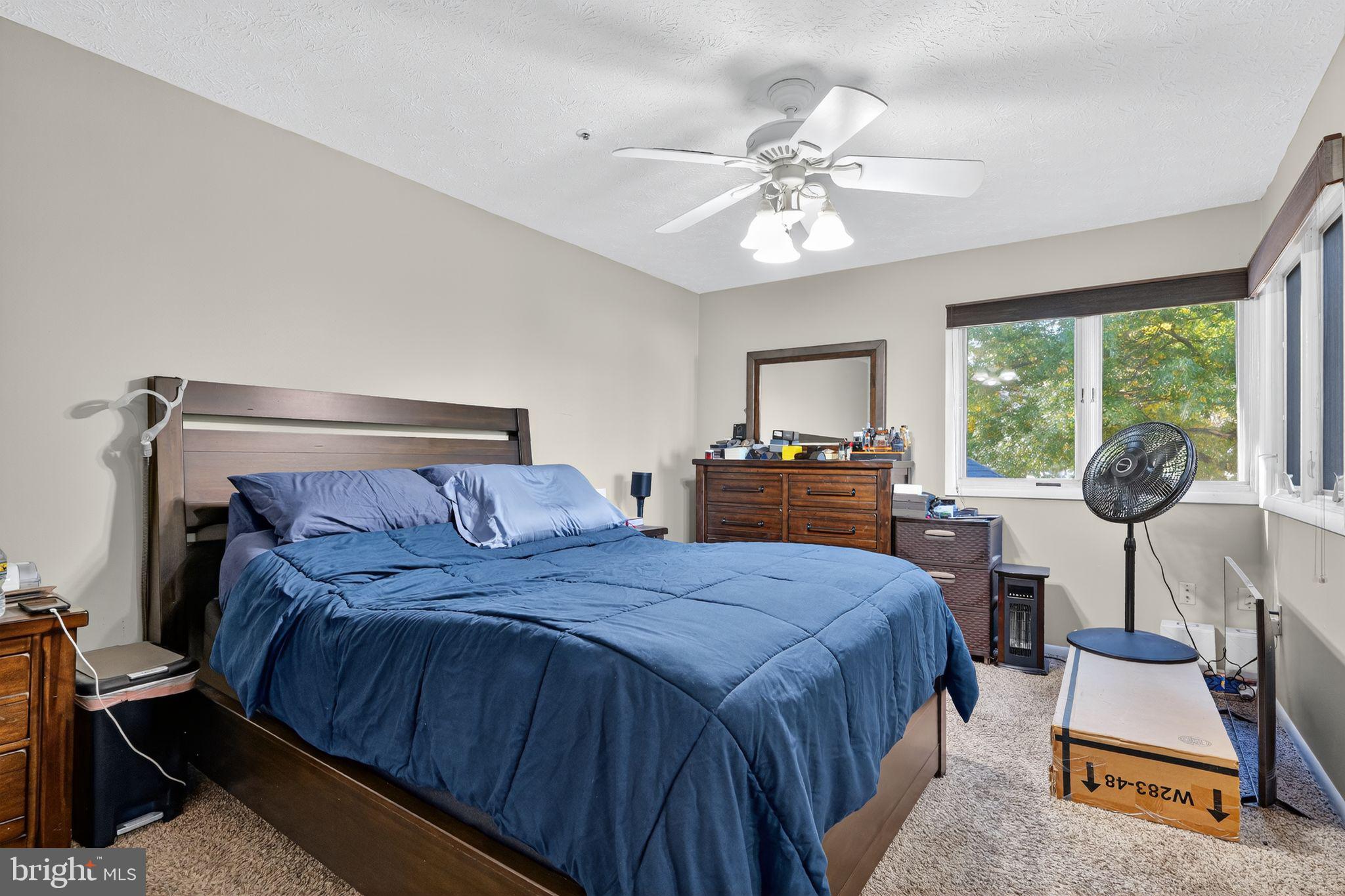 4922 Wealding Way Oxon Hill, MD 20745 - Photo 17 of 24 a bedroom with a bed a dresser next to a window