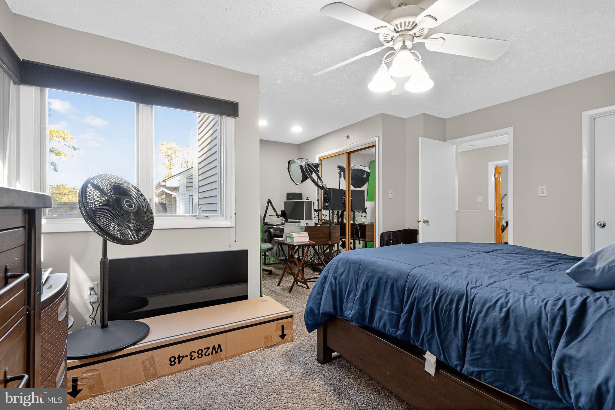 4922 Wealding Way Oxon Hill, MD 20745 - Photo 18 of 24 a bedroom with a bed and a chandelier