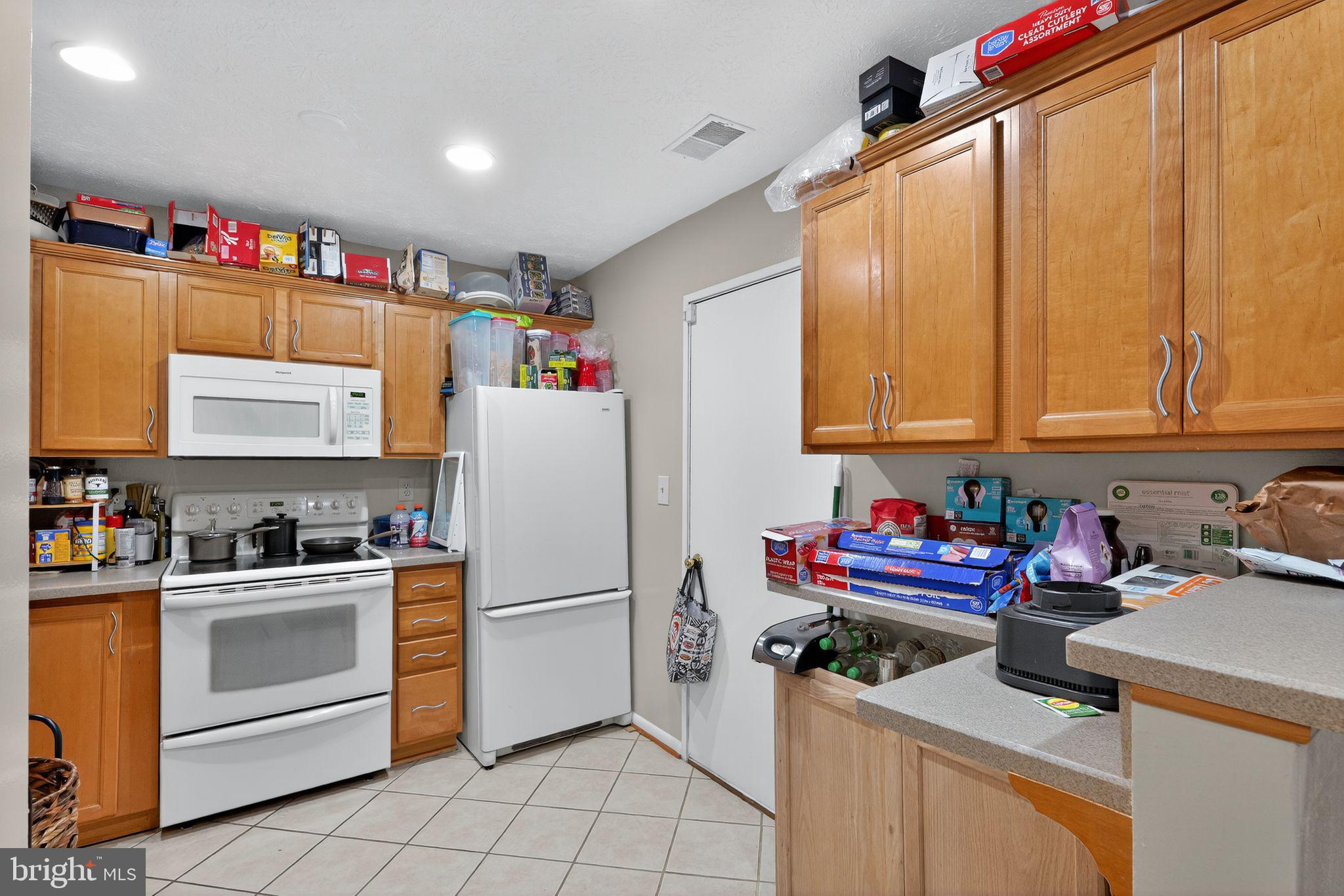 4922 Wealding Way Oxon Hill, MD 20745 - Photo 4 of 24 a kitchen with a refrigerator and cabinets