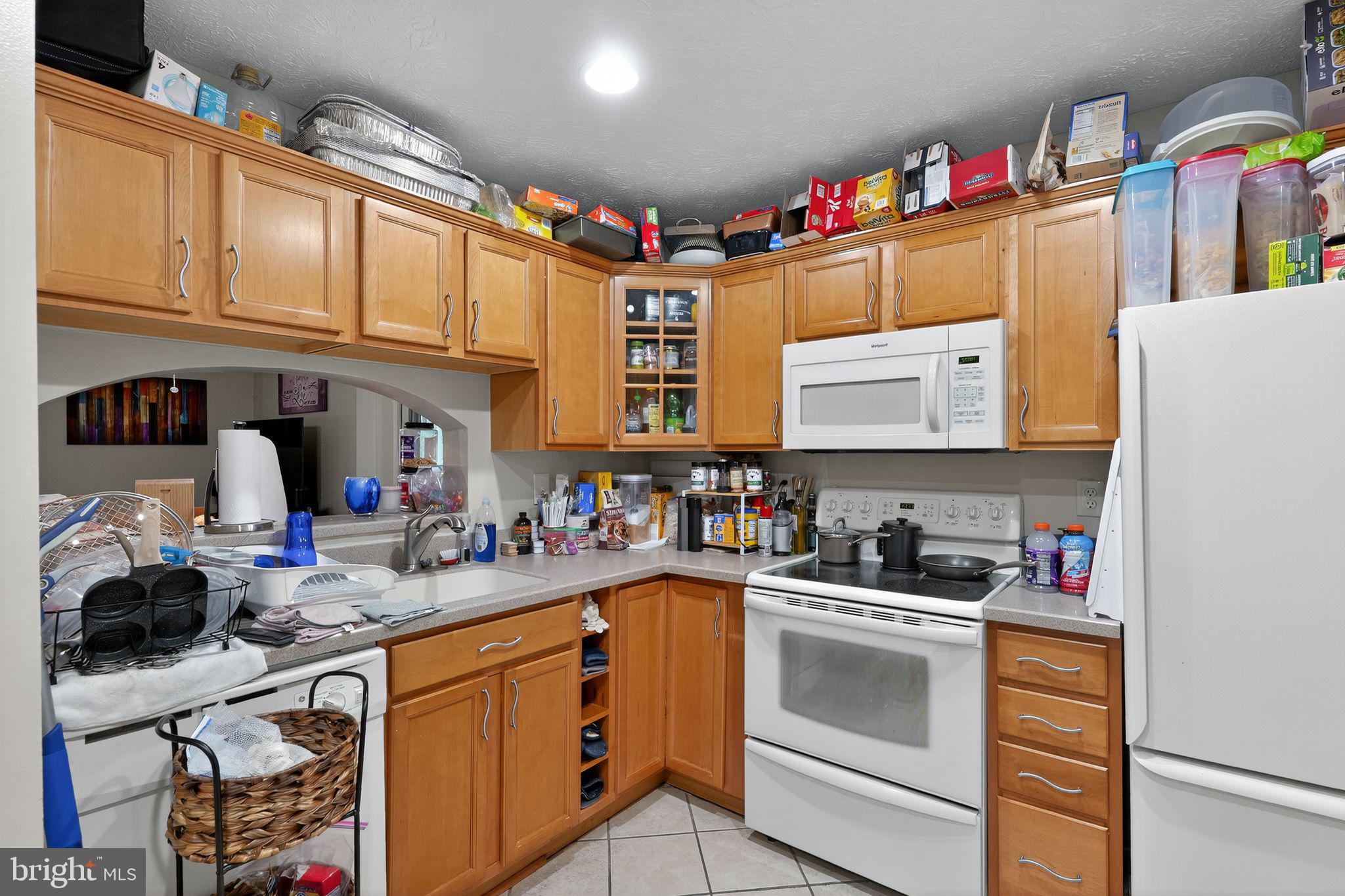 4922 Wealding Way Oxon Hill, MD 20745 - Photo 5 of 24 a kitchen with granite countertop a sink stove and cabinets