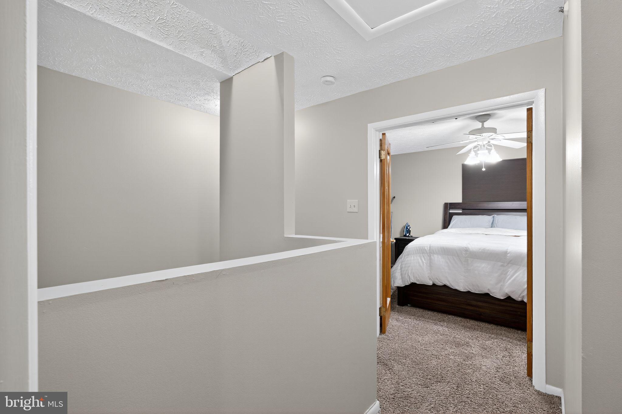 4922 Wealding Way Oxon Hill, MD 20745 - Photo 10 of 24 a bedroom with a bed and lamp