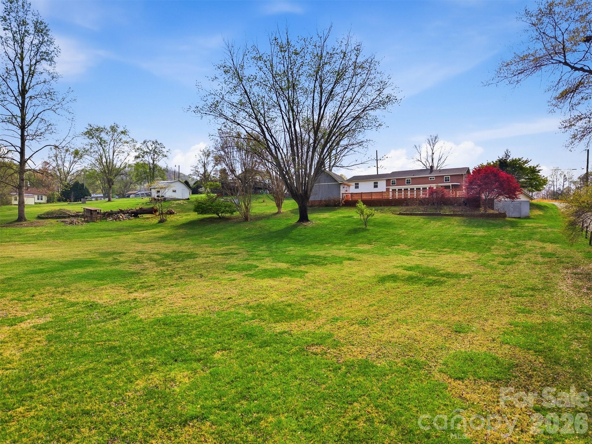2174 Chester Avenue Morganton, NC 28655 - Photo 11 of 38 a backyard of a house with lots of green space and fountain