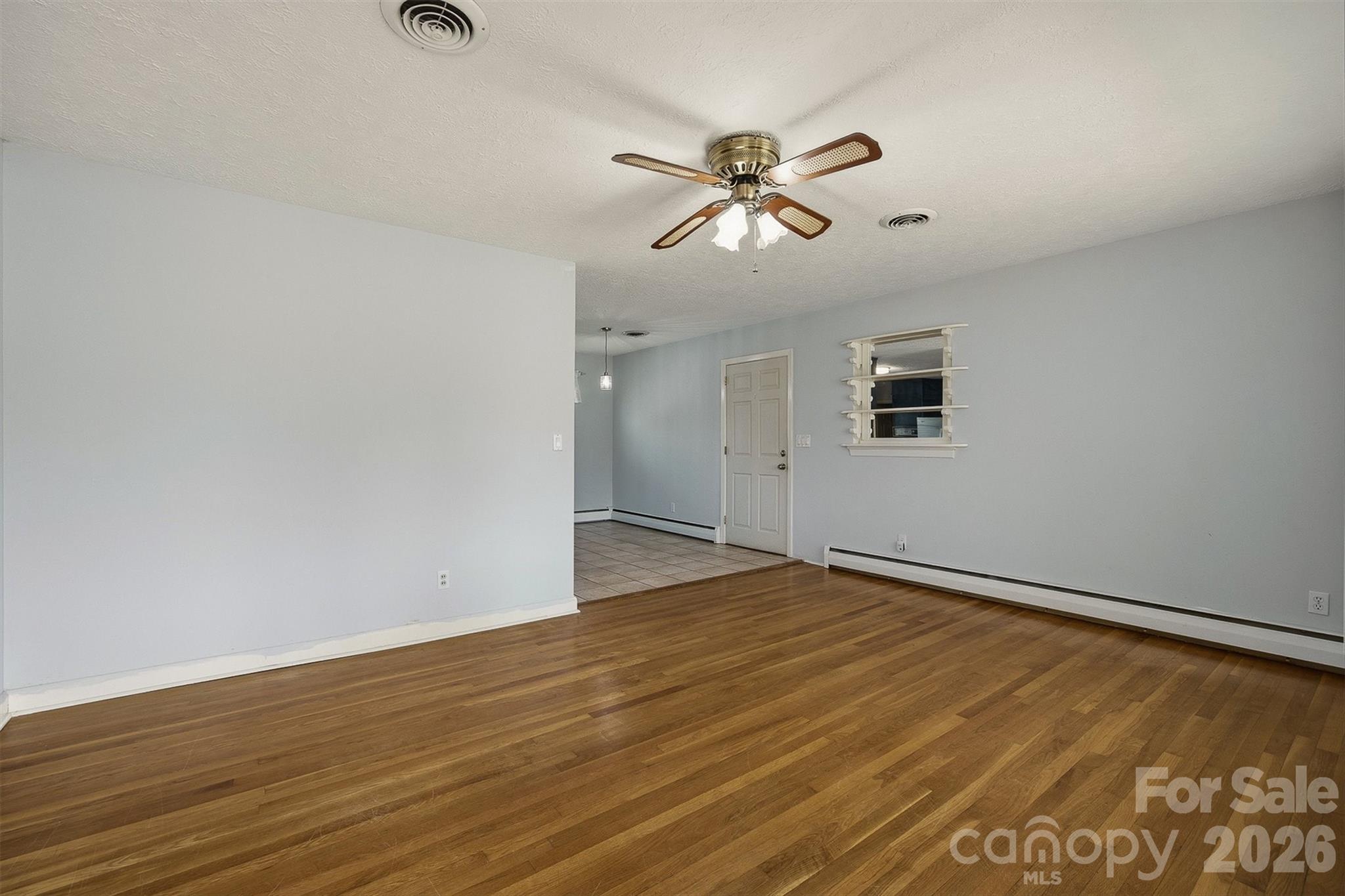 2174 Chester Avenue Morganton, NC 28655 - Photo 21 of 38 a view of an empty room with wooden floor and a window