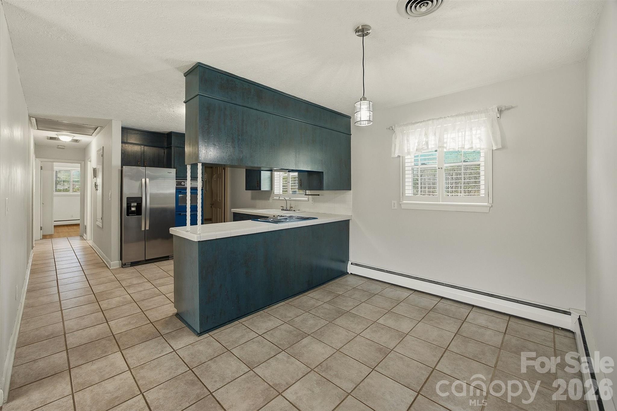 2174 Chester Avenue Morganton, NC 28655 - Photo 23 of 38 a large white kitchen with a stove a refrigerator and a counter top space