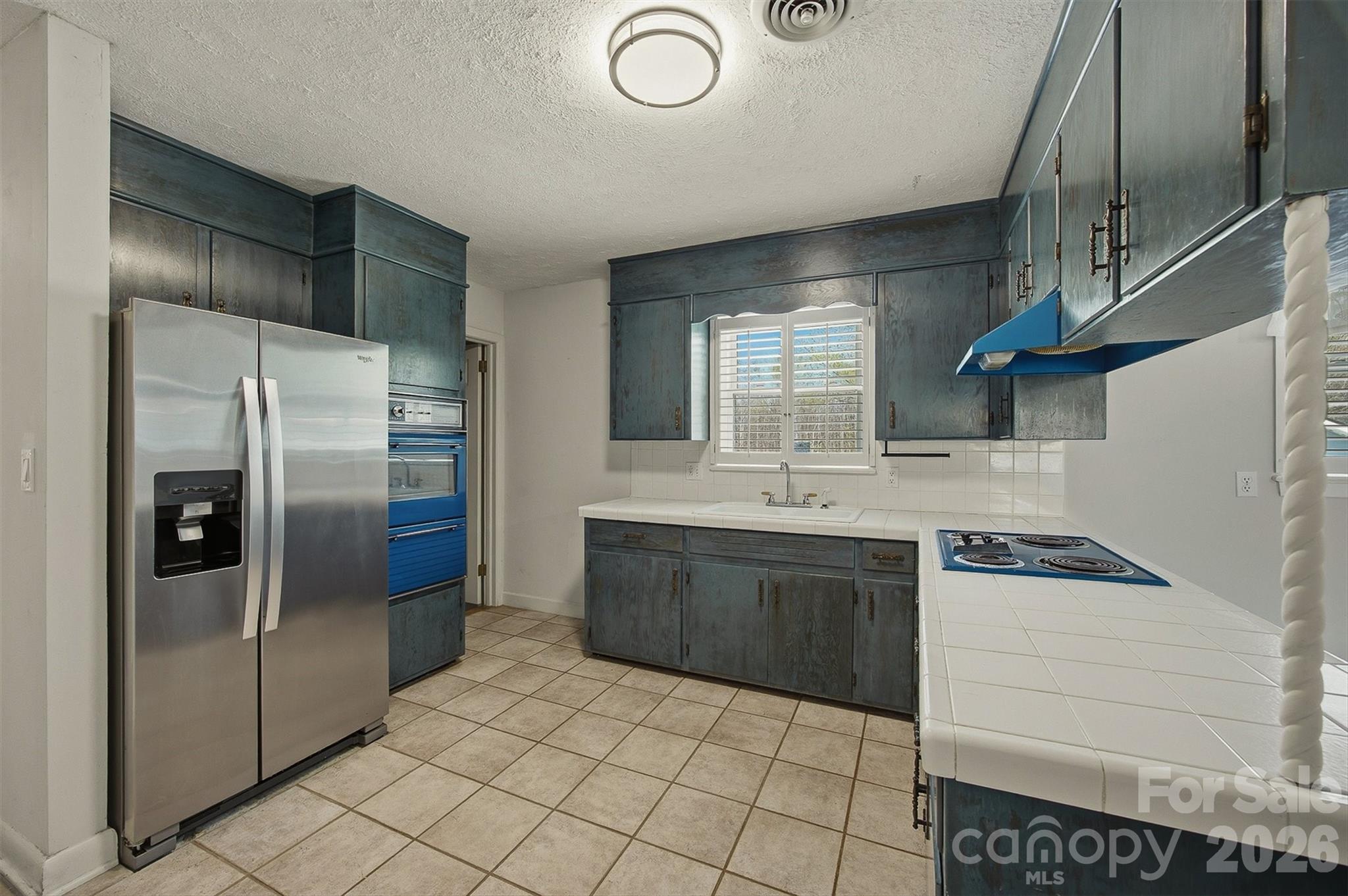 2174 Chester Avenue Morganton, NC 28655 - Photo 24 of 38 a kitchen with stainless steel appliances granite countertop a refrigerator and a sink