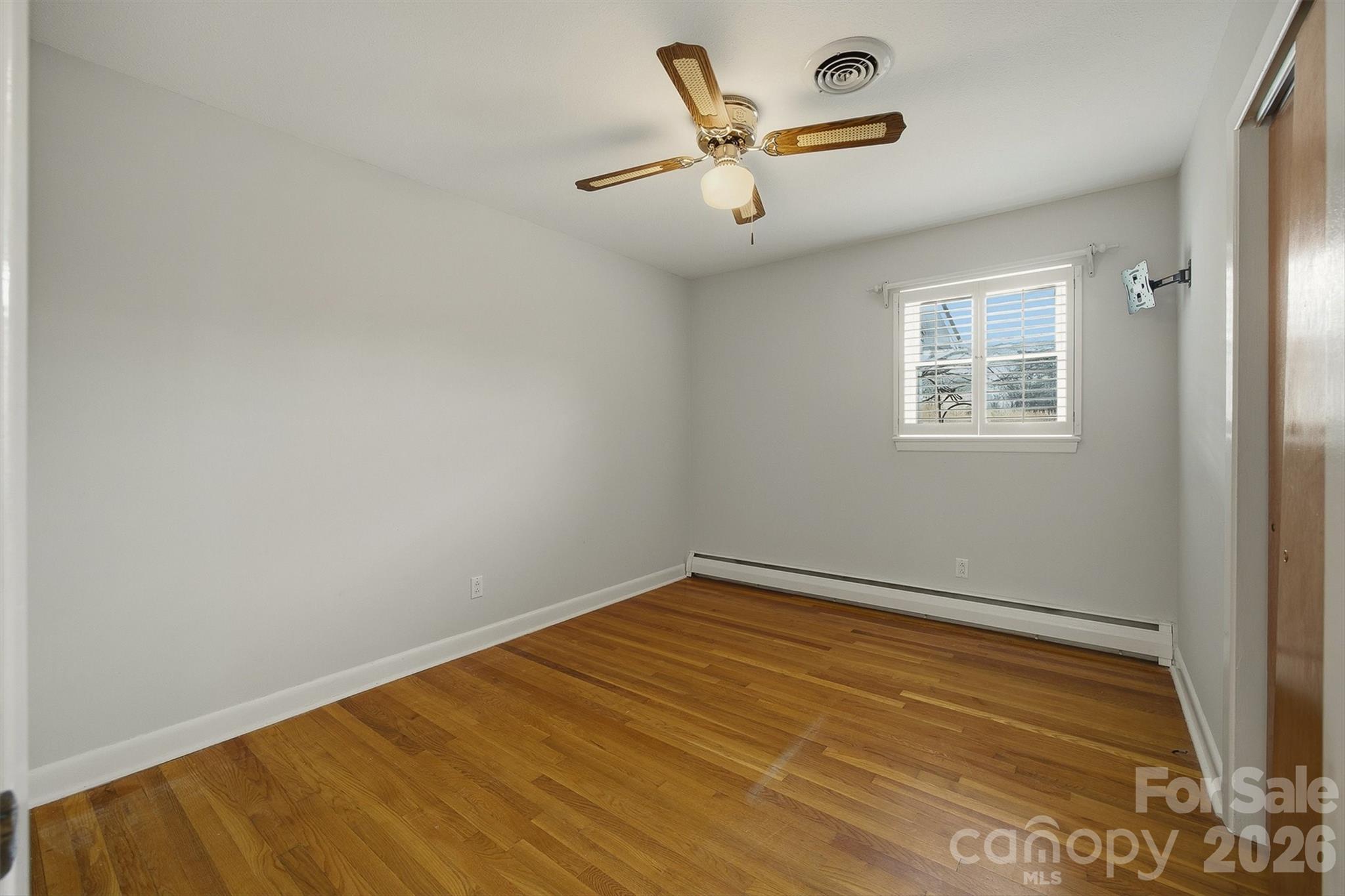 2174 Chester Avenue Morganton, NC 28655 - Photo 25 of 38 an empty room with a window and ceiling fan