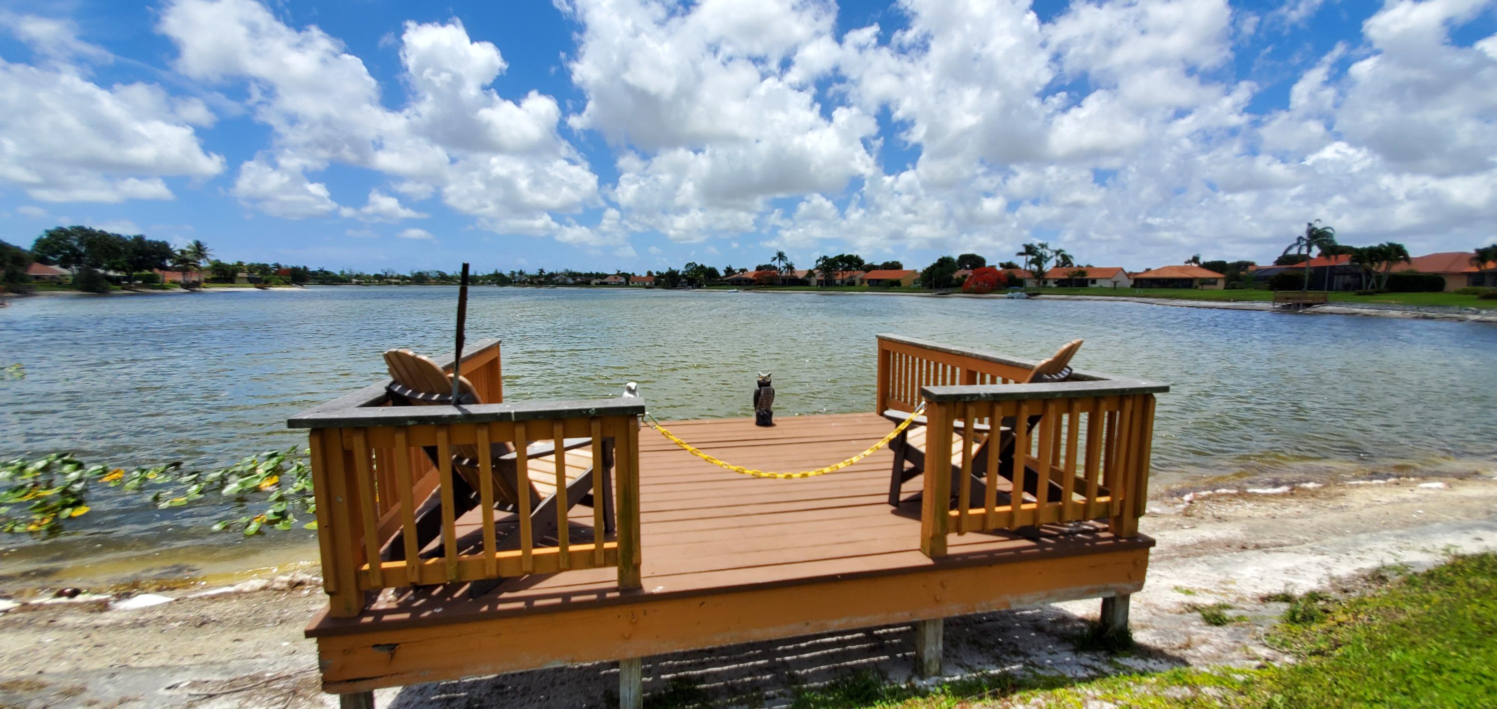 a view of a lake with boats and wooden fence