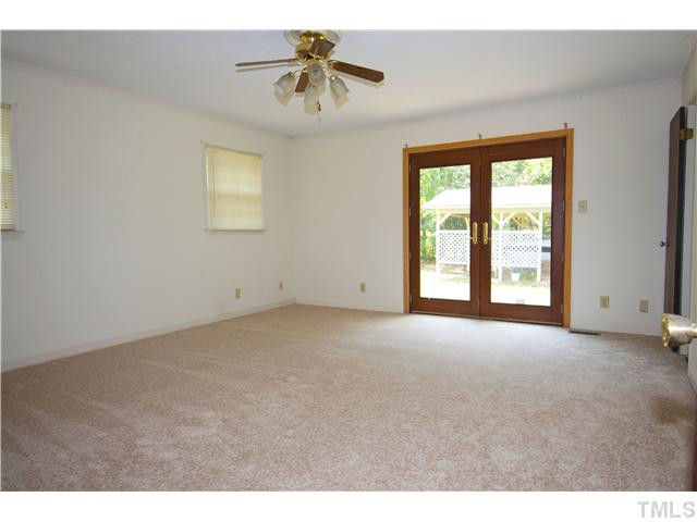 4317 Jimmy Rogers Road Durham, NC 27703 - Photo 12 of 25 Large Master bedroom -- one of five bedrooms -- with french doors, large walk in closet and attached master bath. Master Bedroom