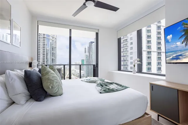 a bedroom with a large bed and a large window