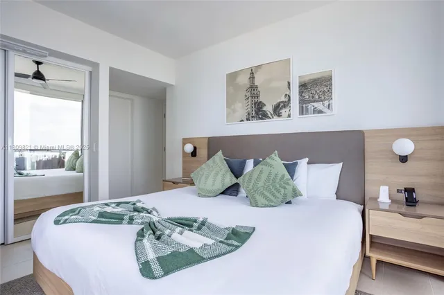 a bedroom with a large bed and a window