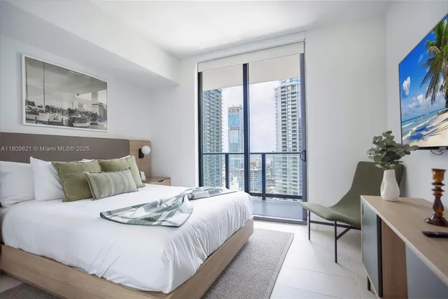 a bedroom with a large bed and a window