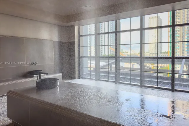 a spacious bathroom with a sink a toilet a mirror and shower