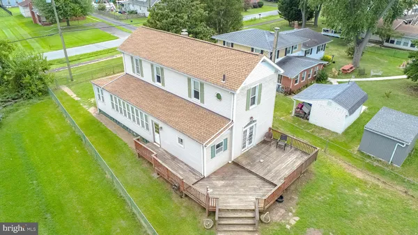 an aerial view of a house with a big yard