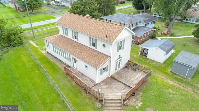 an aerial view of a house with a big yard