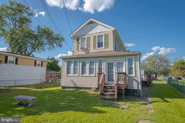 a front view of a house with a garden and yard