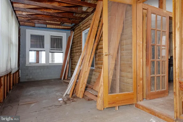 a view of a room with wooden walls and stairs