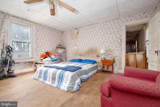 a bedroom with furniture and a large window