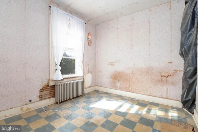 a view of room with window and hardwood floor