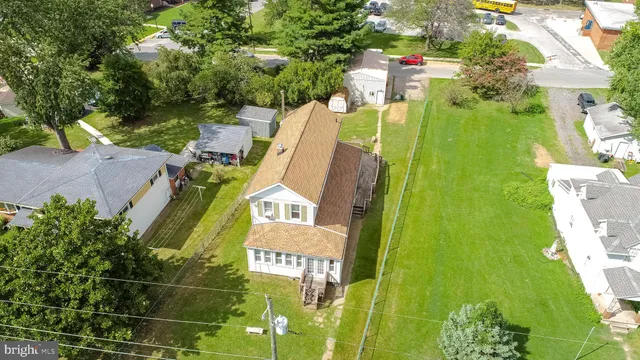 an aerial view of a house with pool garden and outdoor seating
