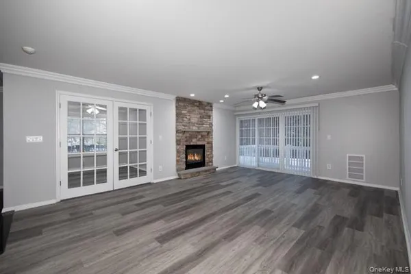 wooden floor in an empty room with a fireplace