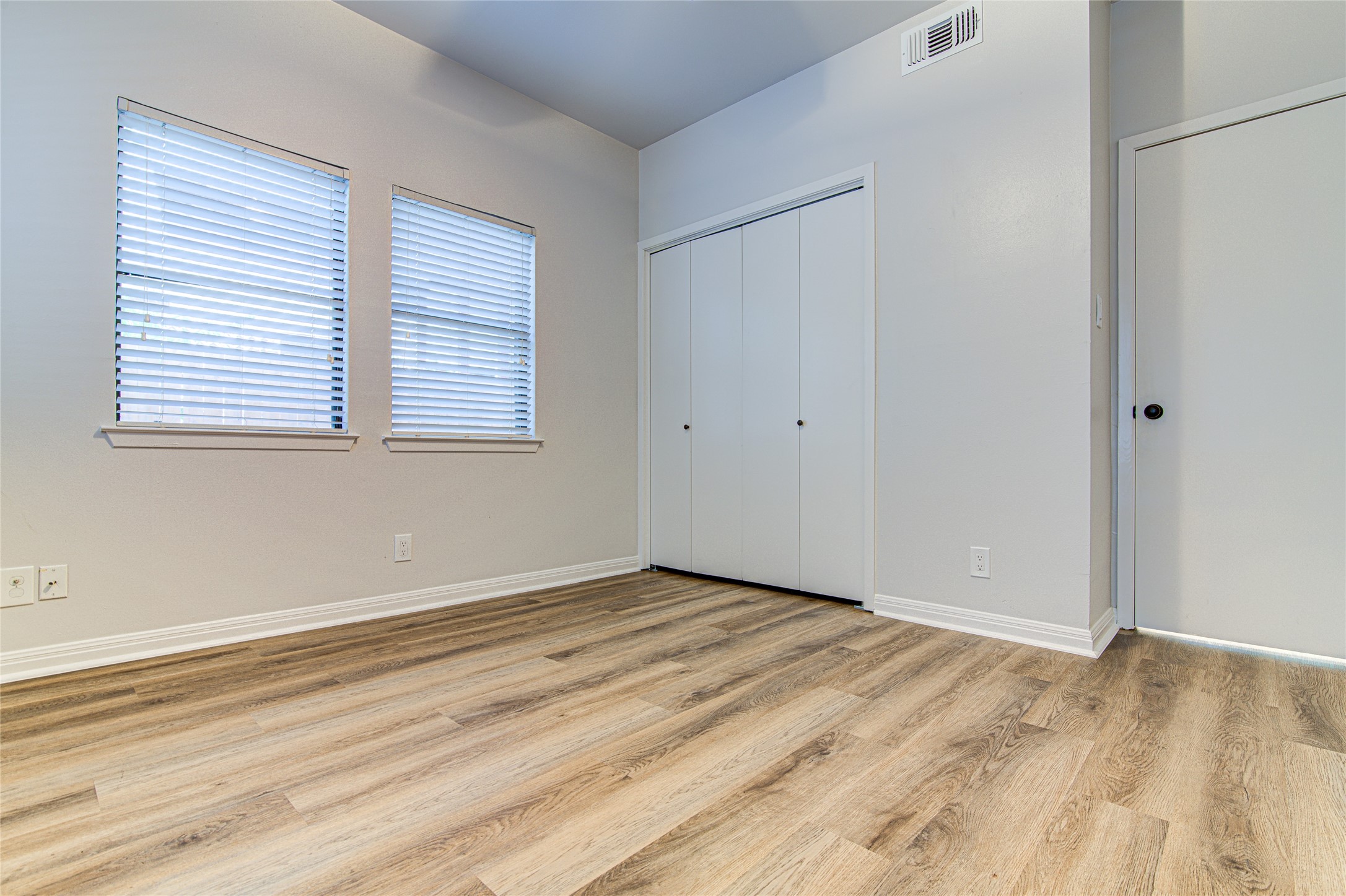 311 West Mary Street Austin, TX 78704 - Photo 30 of 35 Hardwood-style flooring and natural light characterize this well-lit room, ready for personal touches.