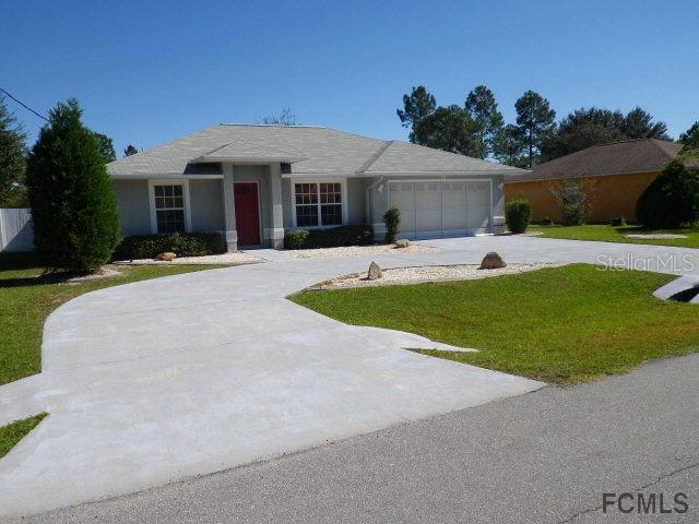 25 Rocking Lane Palm Coast, FL 32164 - Photo 1 of 1 a front view of house with yard and outdoor seating