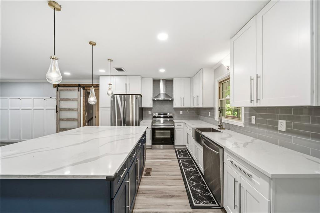 2702 Davenport Road Northwest Duluth, GA 30096 - Photo 10 of 48 a kitchen with stainless steel appliances granite countertop a sink a stove and a refrigerator