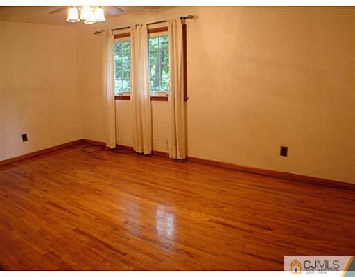 266 Hamlin Road North Brunswick, NJ 08902 - Photo 12 of 17 an empty room with wooden floor and windows