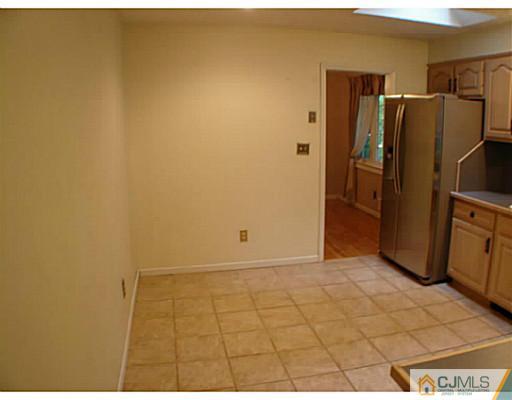 266 Hamlin Road North Brunswick, NJ 08902 - Photo 6 of 17 a view of a refrigerator in kitchen and an empty room