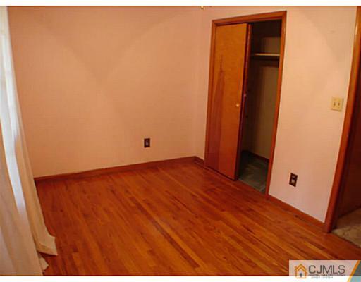266 Hamlin Road North Brunswick, NJ 08902 - Photo 9 of 17 an empty room with wooden floor and closet
