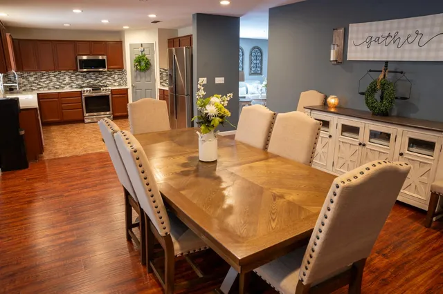 a dining room with furniture and wooden floor