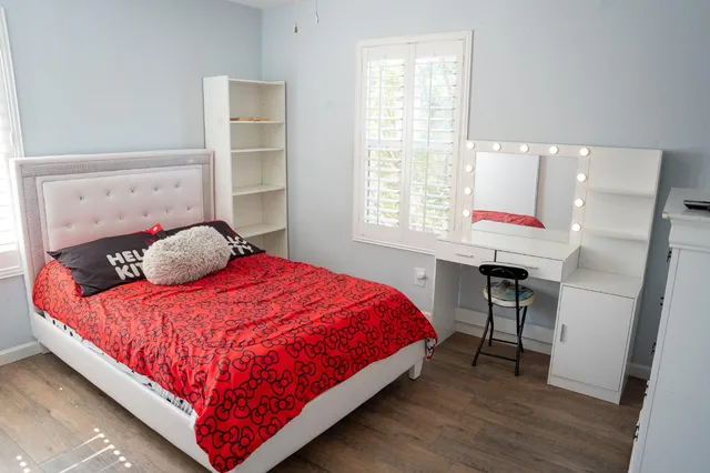 a bedroom with a bed and a window