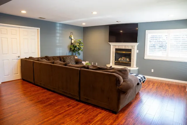 a living room with furniture fireplace and flat screen tv