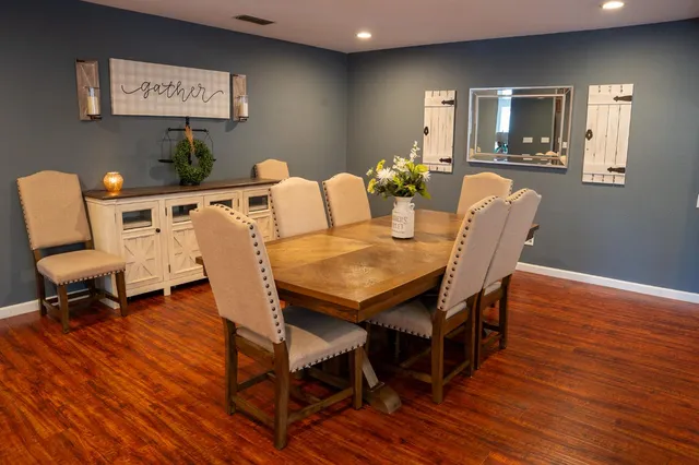 a view of a dining room with furniture and wooden floor