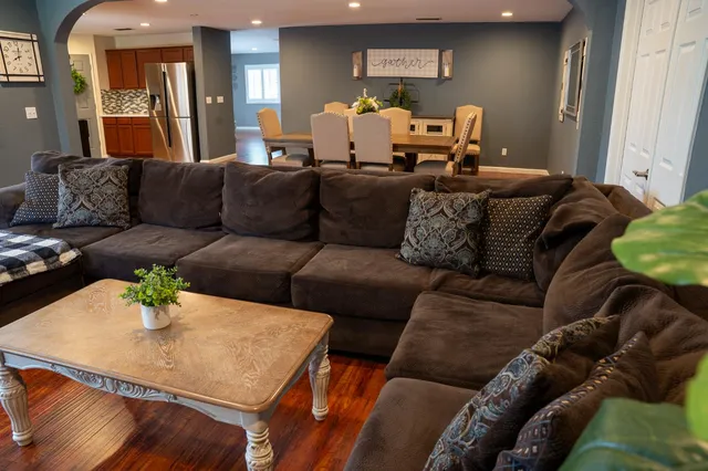 a living room with furniture and wooden floor