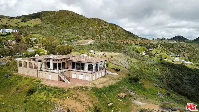 a view of a large building with a mountain